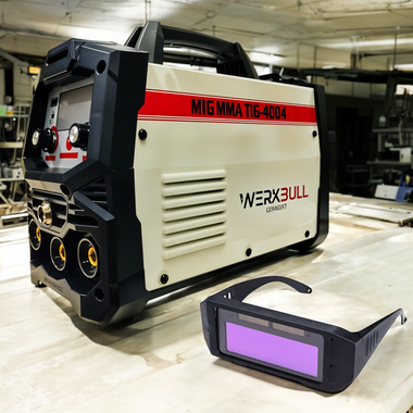 Welding machine with 'WERXBULL' branding and a welding helmet on a workbench.